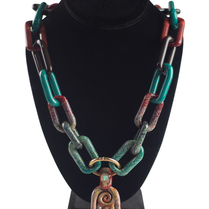 This is a collab glass chain necklace by Technicolor Tony & Maze Glass available at Handmade Glass Co. Made here in Denver and featuring accents from both artists this is a one-of-a-kind impressive glass masterpiece.